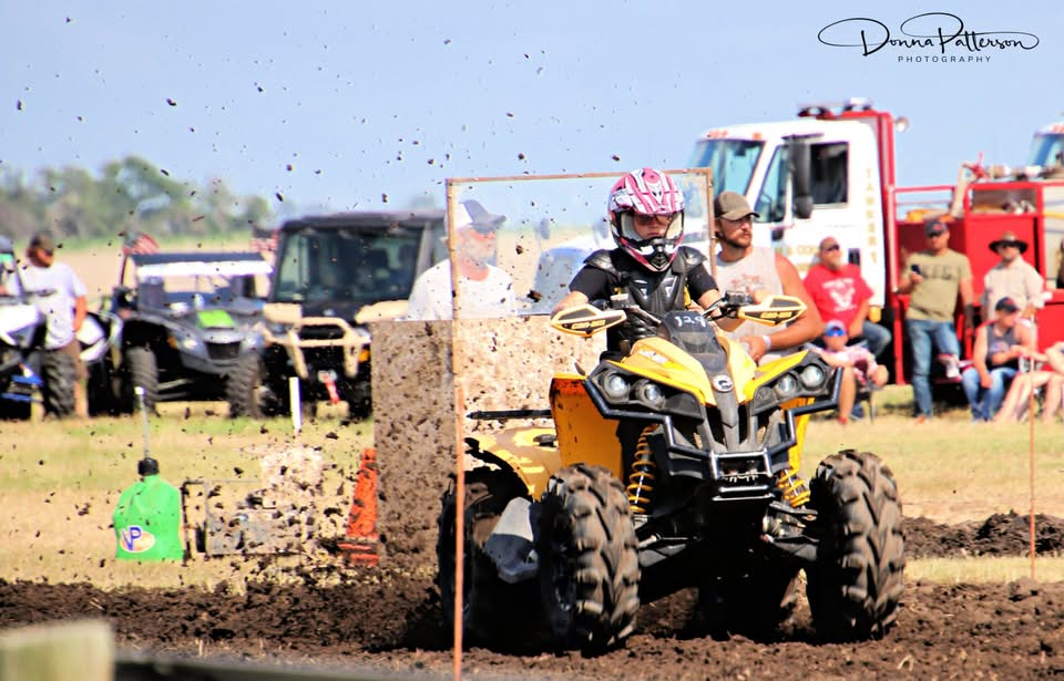 MaKayla racing an ATV through the mud